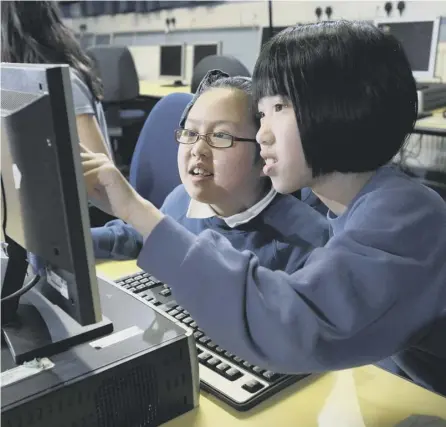  ??  ?? 0 Dalry primary school pupils Kelly Zheng ( right), 10, and Jennifer Shek, nine, work together on a digital animation project in Edinburgh. Picture: Tom Finnie