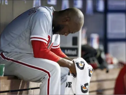  ?? BRYNN ANDERSON — THE ASSOCIATED PRESS ?? Philadelph­ia Phillies starting pitcher Enyel De Los Santos sits in the dugout during the fifth inning of a baseball game against Miami Marlins, Sunday in Miami.