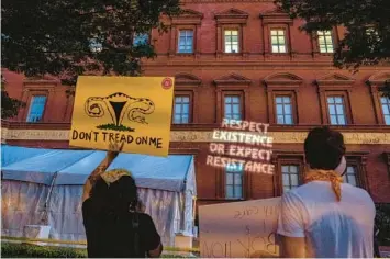  ?? GEMUNU AMARASINGH­E/AP 2022 ?? Abortion-rights protesters carry posters and project a message during an event last summer sponsored by the influentia­l group Susan B. Anthony Pro Life America at the National Building Museum in Washington.