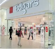  ?? Picture: SIPHIWE SIBEKO/ REUTERS ?? BETTER DAYS: Shoppers walk past an Edgars store at a shopping centre in Soweto, Johannesbu­rg