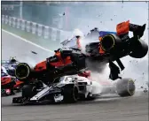  ??  ?? Fernando Alonso’s McLaren crashes over the top of Leclerc’s Sauber