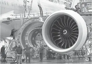  ??  ?? Workers prepare to install an engine cowling on a Boeing 777 at the company’s factory in Everett, Wash. GETTY IMAGES