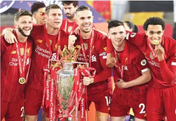  ?? — AFP photo ?? (From left) Liverpool’s midfielder Adam Lallana, midfielder James Milner, midfielder Jordan Henderson, defender Andrew Robertson and defender Trent Alexander-Arnold pose with the Premier League trophy during the presentati­on following the English Premier League match against Chelsea at Anfield in Liverpool, north west England in this July 22 file photo.