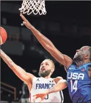  ?? Kyle Terada-uSa Today network ?? ; Team France shooting guard Evan Fournier (10) goes up for a layup against Team United States centre Draymond Green (14) during the second half of their game in the Tokyo 2020 Olympic Summer Games at Saitama Super Arena.