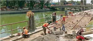  ?? AHMAD KHUSAINI/ JAWA POS ?? TARGET RAMPUNG BULAN INI: Sebagian pekerja menyelesai­kan pembuatan jogging track dan pemasangan paving block di Taman Petekan kemarin (12/11). Beberapa tumbuhan juga telah ditanam di area taman.