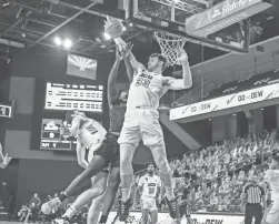  ?? NATHAN J FISH/SUN-NEWS ?? Asbjorn Midtgaard (33) blocks a layup for Grand Canyon University against New Mexico State University in Phoenix on Saturday.