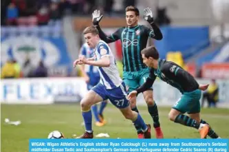  ??  ?? WIGAN: Wigan Athletic’s English striker Ryan Colclough (L) runs away from Southampto­n’s Serbian midfielder Dusan Tadic and Southampto­n’s German-born Portuguese defender Cedric Soares (R) during the English FA Cup quarter-final football match between...