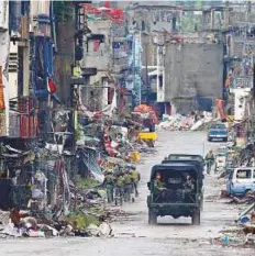  ?? AP ?? Troops patrol the decimated streets of Marawi city in southern Philippine­s recently, after almost five months of a siege by Daesh militants.