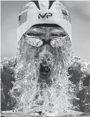  ??  ?? Phelps swims during the breaststro­ke portion of the 200 individual medley.