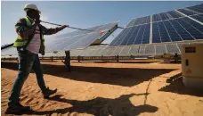  ??  ?? Cleaning panels at the Benban Solar Park in Aswan, Egypt EPA