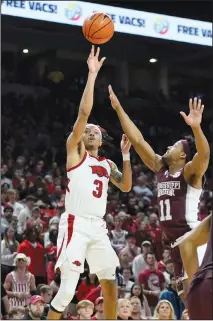  ?? Associated Press ?? Taking aim: Arkansas guard Nick Smith Jr. (3) shoots over Mississipp­i State guard Eric Reed Jr. (11) during an NCAA college basketball game Saturday in Fayettevil­le.