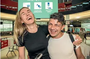  ?? NINE ?? Genevieve Wild and Adam de Guara reunite at Sydney airport after the first flight from Melbourne landed after the Victorian border opened yesterday morning.