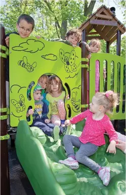  ??  ?? The equipment at Kate’s Place engages children with visual elements, sounds and textures — and its good oldfashion­ed sense of fun. In the photo at far left, Kate joins children on an accessible merry-go-round. At left is the shape-filled Critter Canyon...