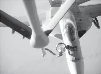  ??  ?? A U.S. navy F-18E Super Hornet receives fuel from a KC-135 Stratotank­er over northern Iraq after conducting airstrikes in Syria on the Islamic State.