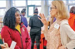  ??  ?? Susan Tabor, from Oklahoma City Community College, speaks with student Ariana Bradley during a teacher career day event Thursday.