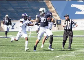  ?? Steve Musco / submitted photo ?? Yale tight end JJ Howland fends off Holy Cross defender John Smith during Saturday’s game.