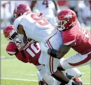  ?? NWA Democrat-Gazette/ANDY SHUPE ?? Arkansas defenders Randy Ramsey (left) and De’Jon Harris tackle Alabama’s Josh Jacobs on Oct. 6. In the past three games, the Razorbacks have faced three of the top offenses in the nation.