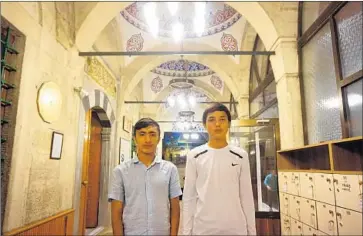  ?? Umar Farooq For The Times ?? ADIL Ahmad, right, and Nuruddin both say their parents are being detained in reeducatio­n camps in China.