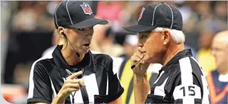  ?? H. Rick Bamman – Shaw Media ?? Line judge Sarah Thomas talks with field judge Rick Patterson during the Saints and Titans
NFL preseason game. Thomas is the first full-time female official in NFL history.