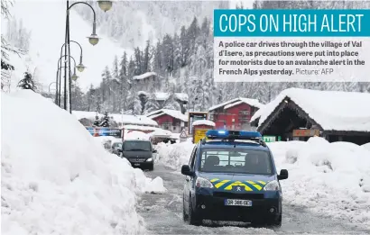  ?? Picture: AFP ?? A police car drives through the village of Val d’Isere, as precaution­s were put into place for motorists due to an avalanche alert in the French Alps yesterday.