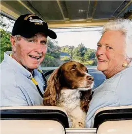  ?? David Hume Kennerly/Getty Images ?? Former U.S. president George H. W. Bush and wife, Barbara Bush, cruise in the back of a golf cart with their dog Millie at their home at Walker’s Point Aug. 25, 2004 in Kennebunkp­ort, Maine.
