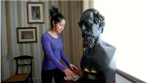  ?? GETTY IMAGES ?? A woman cleans a table next to Dickens’ death mask in a bedroom inside the Charles Dickens Museum in London. The museum is located in Charles Dickens’ house on Doughty St, where he lived from 1837 until 1839 and in which he wrote many novels including Oliver Twist and Nicholas Nickleby.