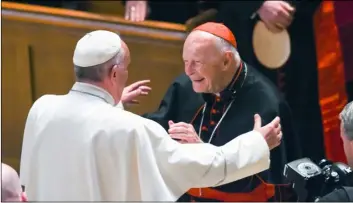 ??  ?? In this 2015 file photo, Pope Francis reaches out to hug Cardinal Archbishop emeritus Theodore McCarrick after the Midday Prayer of the Divine with more than 300 U.S. Bishops at the Cathedral of St. Matthew the Apostle in Washington. JonAthAn...