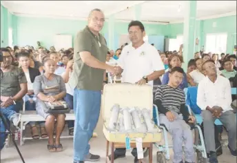  ?? (DPI photo) ?? Ministeria­l Advisor in the Ministry of Indigenous Peoples’ Affairs and Member of Parliament, Mervyn Williams (left) handing over the water pumps to councillor of Kamwatta village, Maurice Henry.