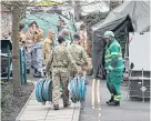  ??  ?? Military and emergency services outside Salisbury Police Station.