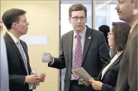  ?? Elaine Thompson Associated Press ?? WASHINGTON STATE Atty. Gen. Bob Ferguson, center, with members of his staff, filed the lawsuit against Trump’s travel ban that has halted it nationwide.