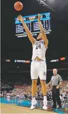  ?? DAVID J. PHILLIP THE ASSOCIATED PRESS ?? Villanova’s Omari Spellman shoots a 3-pointer against Kansas on Saturday in the Final Four in San Antonio. He finished with 15 points in the win.