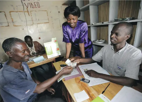  ?? BRENT STIRTON/GETTY IMAGES ?? With M-Pesa, the result of one man’s desire to improve life for people around him, clients in Kenya can make financial transfers via mobile phone operations.