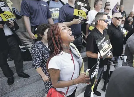  ?? Photograph­s by Rich Pedroncell­i Associated Press ?? ERICA MURPHY, a member of Ironworker­s Union Local 378, takes part in a Sacramento rally in support of an employee benefits bill.