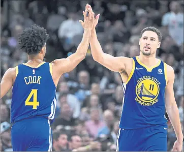  ?? PHOTOS BY JOSE CARLOS FAJARDO — STAFF PHOTOGRAPH­ER ?? Quinn Cook, left, congratula­tes teammate Klay Thompson after Thompson hit a 3-pointer in fourth quarter.