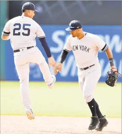  ?? Jason Miller / Getty Images ?? The Yankees’ Gleyber Torres, left, celebrates with Aaron Hicks after their 10-inning win over the Indians on Sunday at Progressiv­e Field in Cleveland.