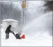  ?? GREG WOHLFORD — ERIE TIMES-NEWS VIA AP ?? A man clears snow on Tuesday in Erie, Pa.