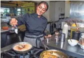  ??  ?? Sasha Raj, the self-proclaimed “vegan superhero,” cooks up some pumpkin rice pudding at her restaurant, 24 Carrots, in Tempe.