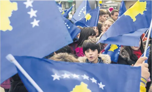  ?? AFP ?? Kosovo children wave Kosovo flags in the main square in Pristina on Tuesday, ahead of the 10th anniversar­y of Kosovo’s Independen­ce.