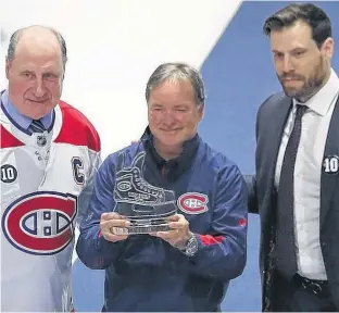  ?? USA TODAY SPORTS ?? Member of the Montreal staff Pierre Gervais receives a gift from former player Bob Gainey, left, and defenceman Shea Weber before a recent regular season game at the Bell Centre.