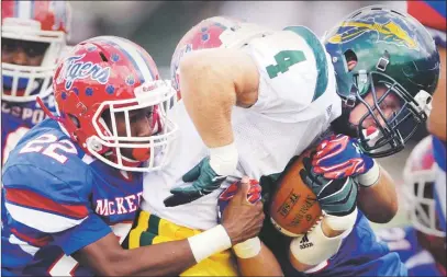  ?? Pam Panchak/Post-Gazette Penn-Trafford’s Devin Austin fights for yardage against McKeesport defenders Ben Davis, left, and Justice Smith Saturday in the Warriors’ 28-0 victory. ??