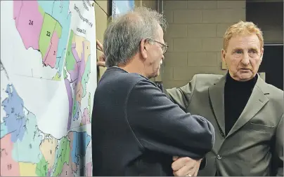  ?? COLIN MACLEAN/TC MEDIA ?? Alcide Bernard, left, chairman of the community of Wellington, chats with Gerard Mitchell, chairman of the P.E.I. Electoral Boundaries Commission, following a meeting in Abram-Village Tuesday night.