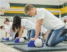  ?? GARY YOKOYAMA THE HAMILTON SPECTATOR FILE PHOTO ?? High school students perform chest compressio­ns on a dummy in 2017. To improve cardiac arrest survival rates and improve outcomes, we need to build a culture of cardiac safety, Doug Roth writes.