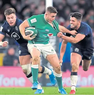  ?? Picture: PA. ?? Scotland’s Adam Hastings, right, tackles Ireland’s Jordan Larmour during the Guinness Six Nations match at the Aviva Stadium, Dublin.