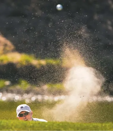  ??  ?? Brian Rousel hits out of a sand trap Wednesday on the 18th hole of the Marty Sanchez Links de Santa Fe Golf Course. Officials are celebratin­g the course’s 20 years of existence.