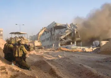  ?? AFP/ISRAELI ARMY ?? Israeli imagery released Saturday shows soldiers taking up positions near an army bulldozer in the Gaza Strip.