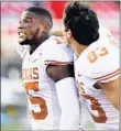  ?? MARK ROGERS/AP ?? Texas’ Chris Brown and wide receiver Kai Money celebrate their win over Texas Tech on Saturday.