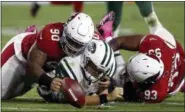  ?? ROSS D. FRANKLIN — ASSOCIATED PRESS ?? Jets quarterbac­k Ryan Fitzpatric­k loses the football as he is hit by Cardinals defensive tackle Robert Nkemdiche, left, and defensive end Calais Campbell during the first half of Monday night’s 28-3 loss to Arizona in Glendale, Ariz. The play was ruled...