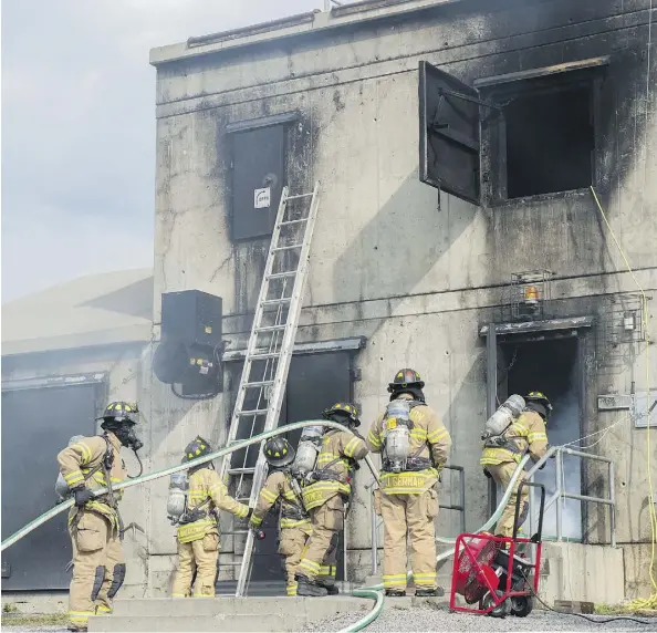  ?? SHAUGHN BUTTS ?? Firefighte­rs undergo training at the Edmonton Fire Rescue Services’ Poundmaker facility on Thursday.