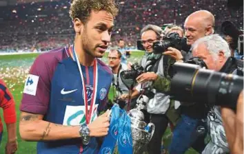  ?? AFP ?? Neymar Jr celebrates with the trophy at the end of PSG’s French Cup final victory against Les Herbiers at the Stade de France in Saint-Denis, outside Paris, last week.