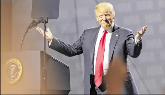  ?? BOB ANDRES / AJC ?? President Trump acknowledg­es the crowd as he takes the stage at the National Rifle Associatio­n’s annual meeting in Atlanta, the first visit from the president to Georgia since his election. He was welcomed as a hero at the Georgia World Congress Center.